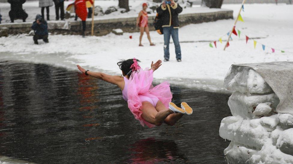 Swimmer jumping into lake