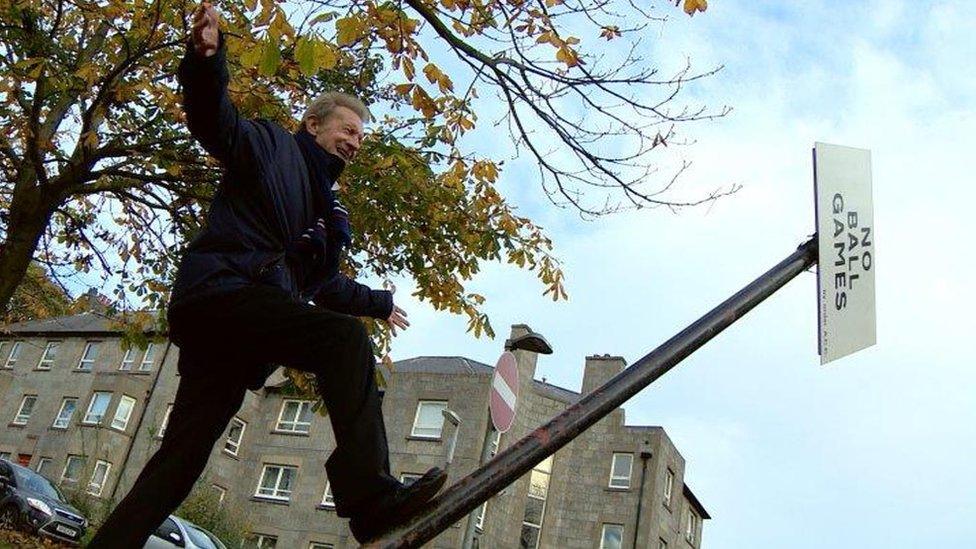 Denis Law removes sign