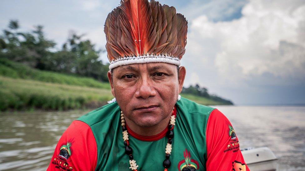 Oliveira Tikuna sitting in a canoe