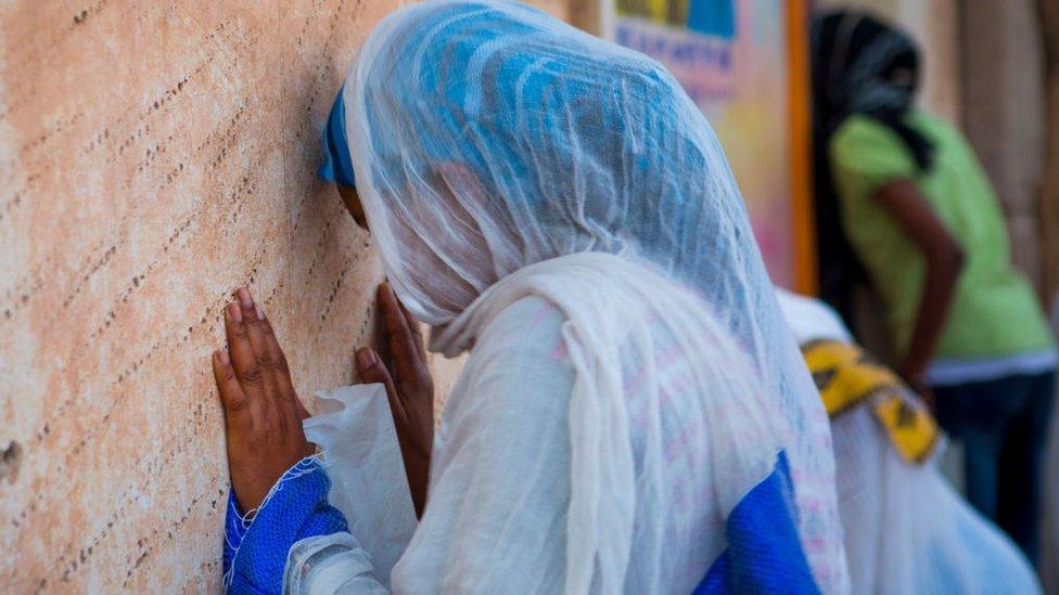 Asmara, people praying in a church