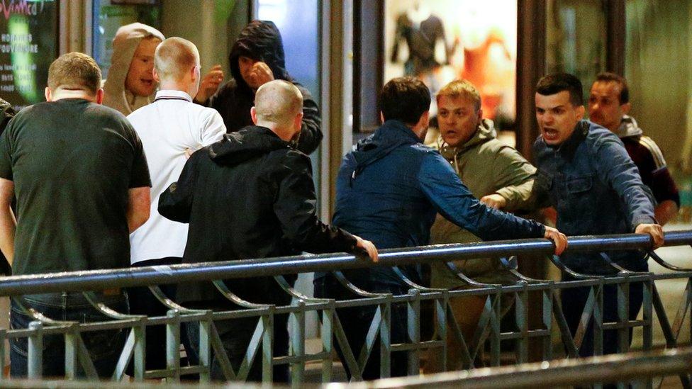 Russian supporters (right) scuffle with England supporters in Lille city centre shortly after midnight on 15 June 2016