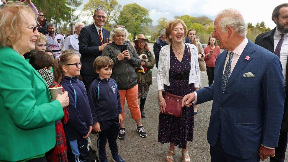 The Prince of Wales greets people in the car park during a visit to Slieve Gullion Forest Park in Meigh, Newry, on 18 May 2021