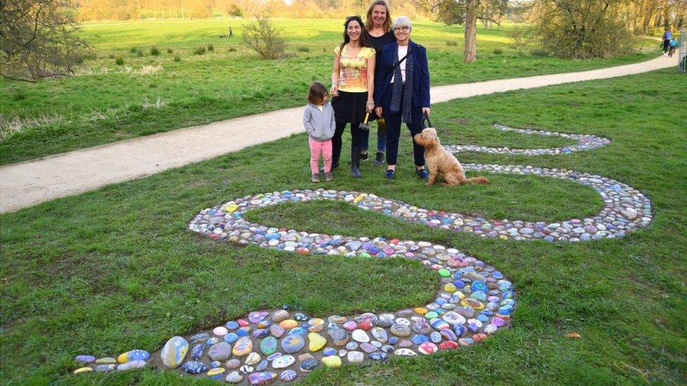 A dog on a lead, Anna Earnshaw, mural artist Sarah Hodgkins of Charlotte Designs Potterspury and Karyna Clifford with her daughter