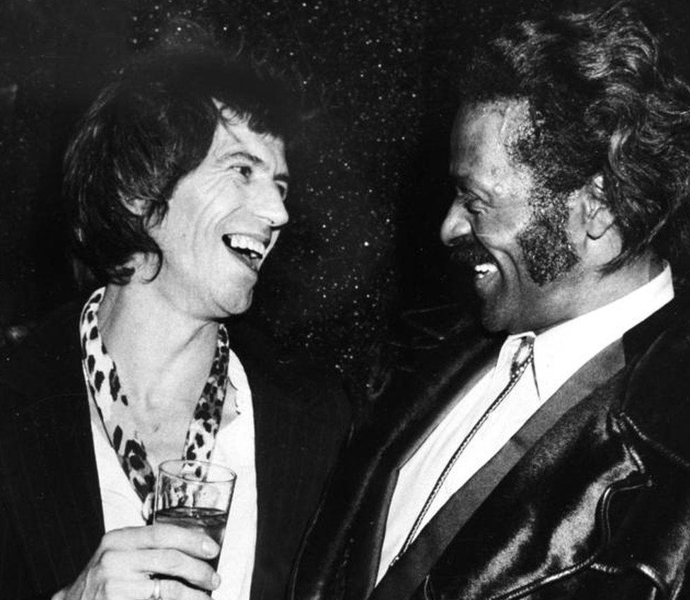 Chuck Berry, right, laughs with fellow guitarist Keith Richards of the Rolling Stones at New York's Studio 54 in February 1980.