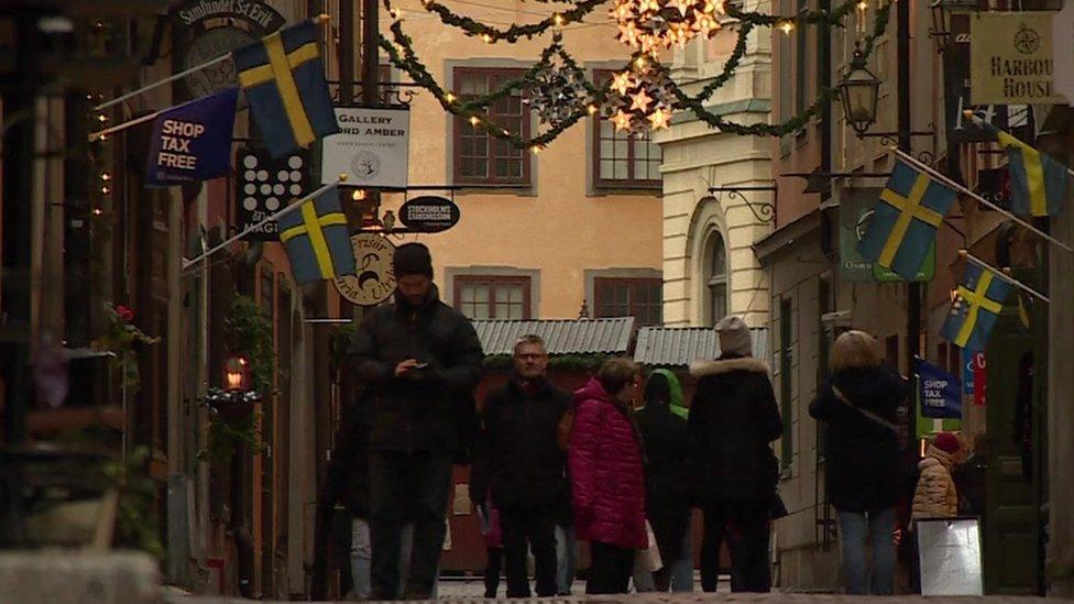 People walk on a street in Stockholm