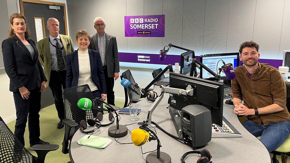 a group of people in a radio studio