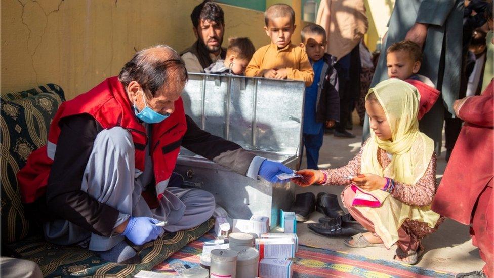 pharmacist from one of the Afghan Red Crescent's mobile health teams giving medicines