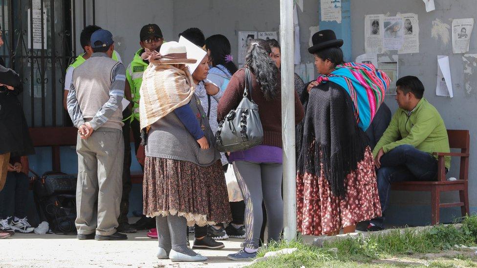 Relatives wait outside the morgue of the Clinicas Hospital, in La Paz, Bolivia