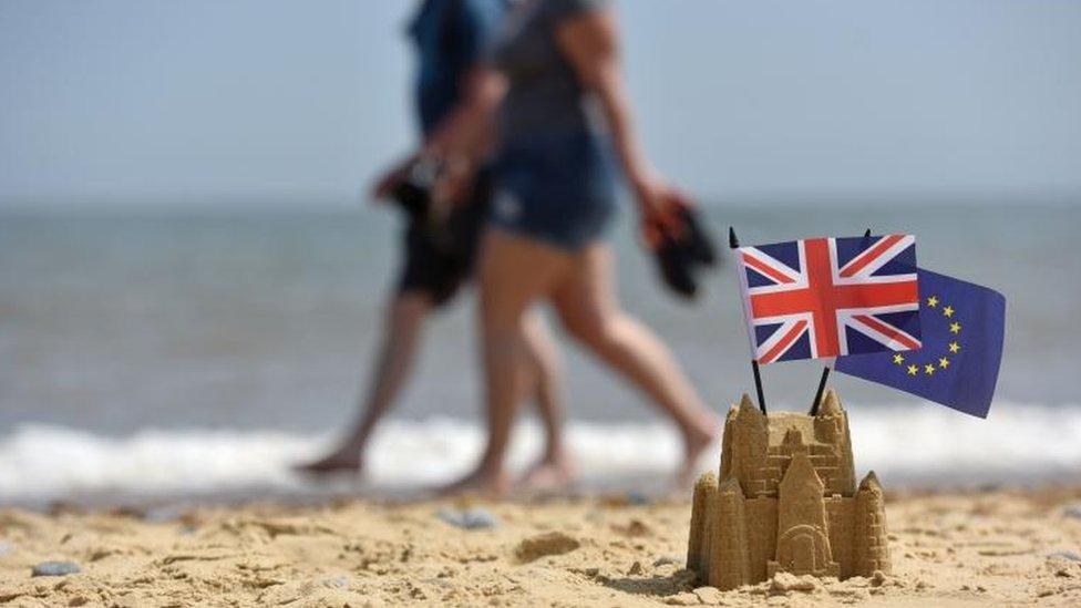 Sandcastle with UK and EU flags