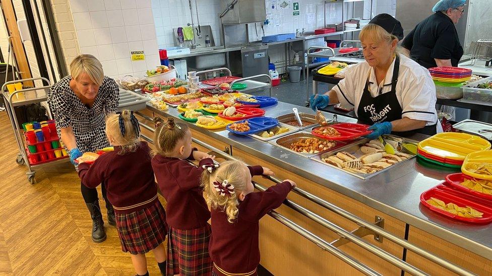 Children being served school dinners