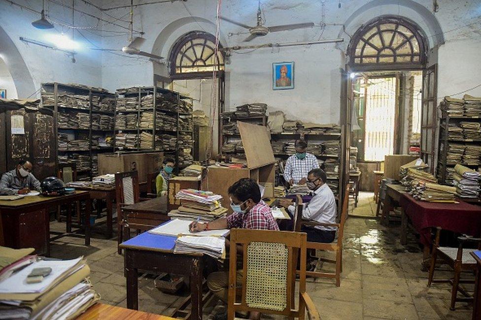 Civil-Servants work at an office of the Uttar Pradesh state government in Allahabad on June 21, 2021 after the state allowed public and private offices to function in full capacity post the lockdown that was imposed earlier to curb the spread of Covid-19 coronavirus