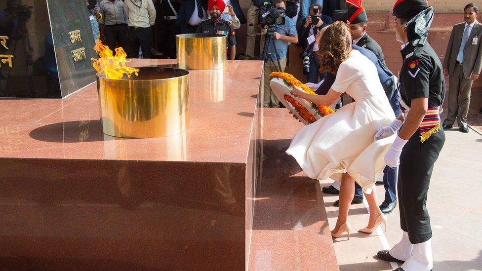 The Duchess of Cambridge struggles to control her dress in strong winds as the Duke and Duchess of Cambridge lay a wreath at the India Gate, in New Delhi to honour the soldiers from Indian regiments who served in World War One