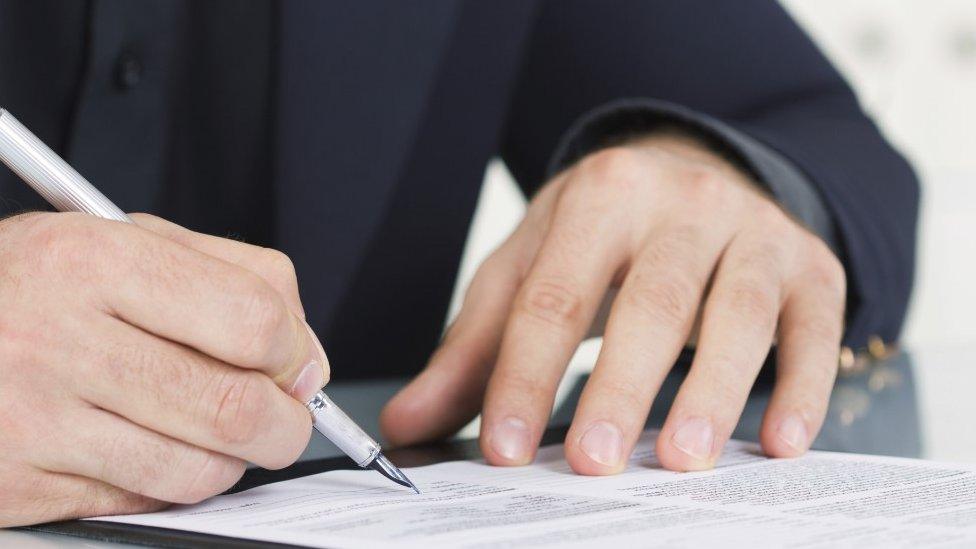 Man signing a contract