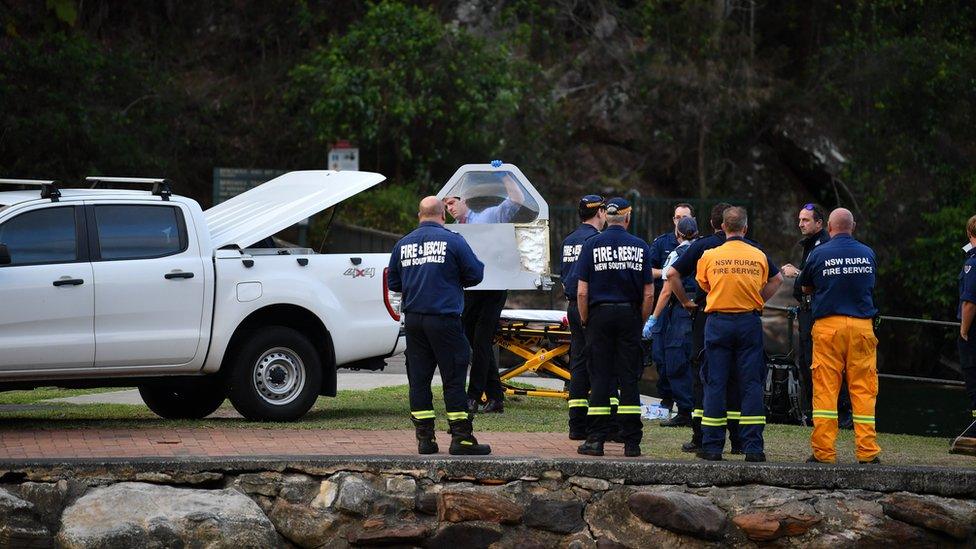 emergency services staff next to a river