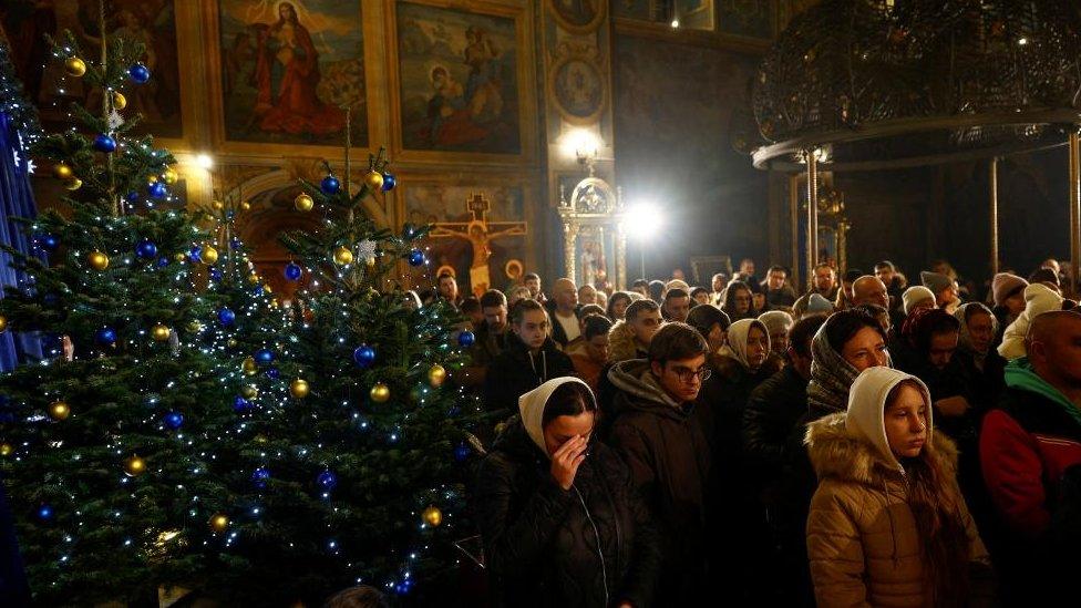 Believers attend a Christmas Eve service at the St Michael's Golden-Domed Cathedral (Mykhailivskyi Zolotoverkhyi)