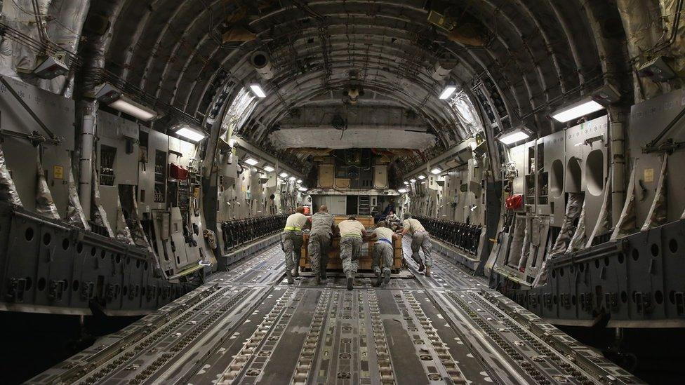 Ammunition is loaded onto the cavernous bay of a US C-17 Globemaster jet, 9 January 2016