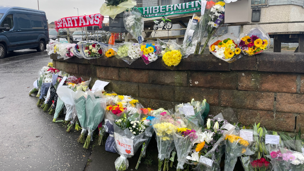 Floral tributes have been left outside the Anchor Inn in Granton following the shooting of Marc Webley on Hogmanay