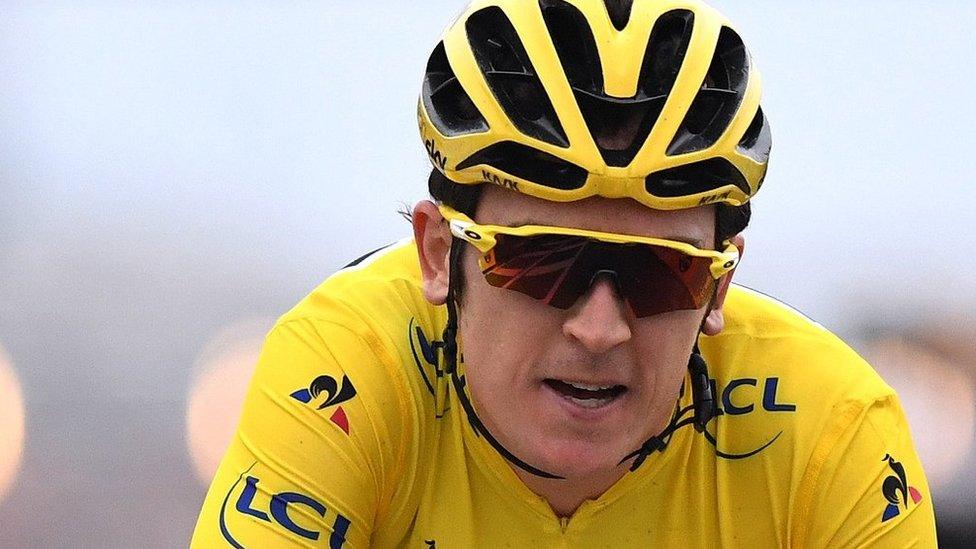 Geraint Thomas in action wearing a yellow crash helmet and sunglasses