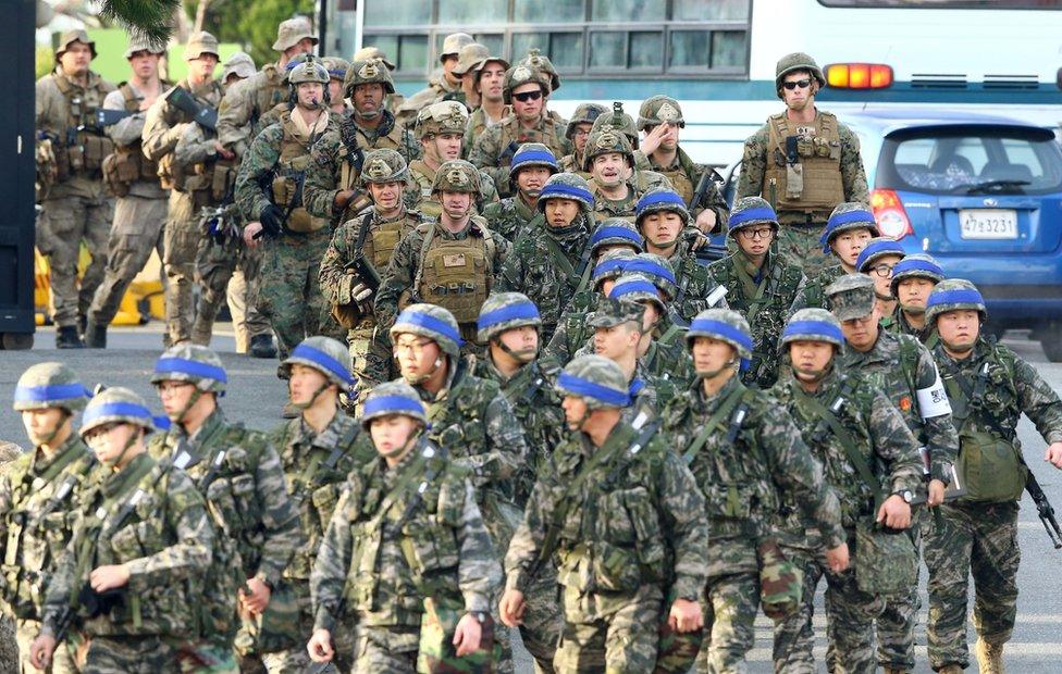 Marines from South Korea (front) and the US (top) move for a joint military drill by US and South Korea in the southeastern port of Pohang on 7 March 2016