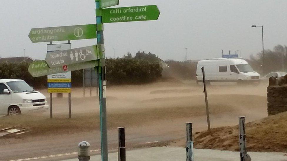 Wind blowing beach sand over road at Llanelli’s North Dock