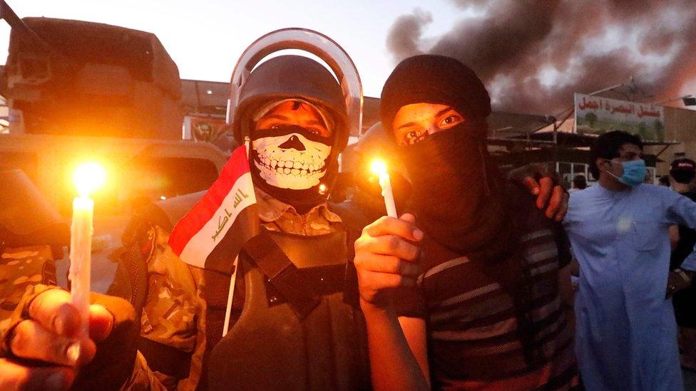 Protesters hold candles near a government building in Iraq's Basra, 6 September 2018