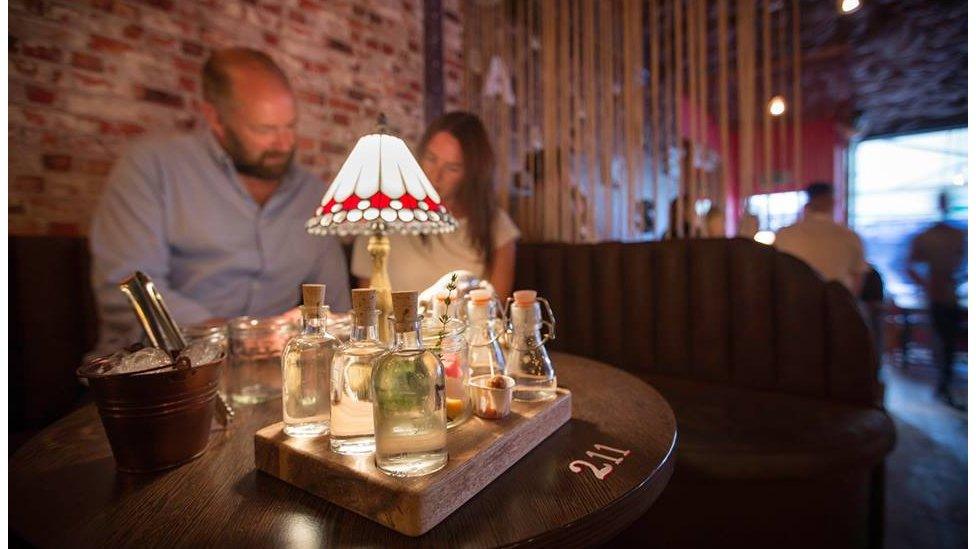 A couple sit and enjoy their drink at the Gin Tub