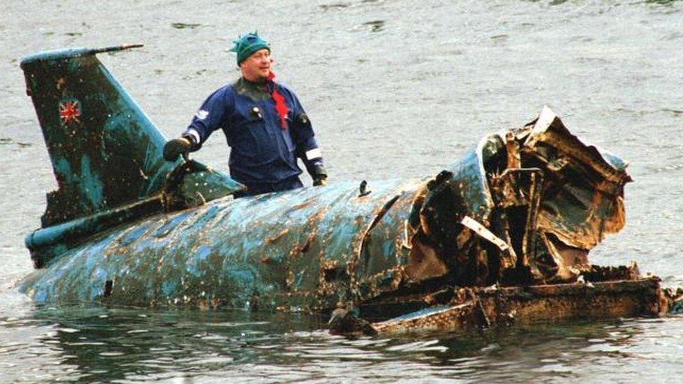 Bill Smith with the Bluebird wreckage as it was lifted from Coniston Water in 2001