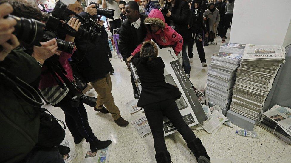 People fighting over a television