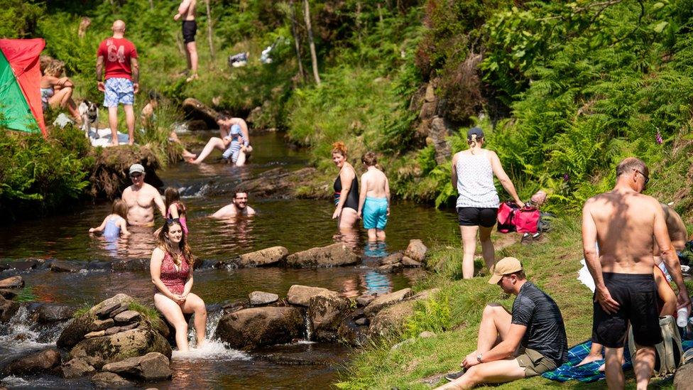 People enjoy the hot weather by Three Shires Head on the River Dane, where Cheshire, Derbyshire and Staffordshire meet