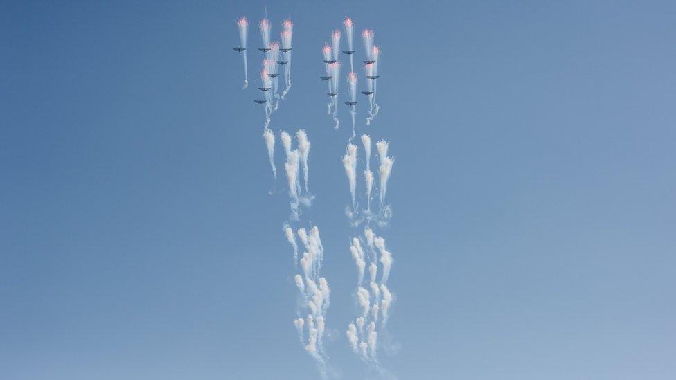 Aircrafts perform a fly-by during a mass rally