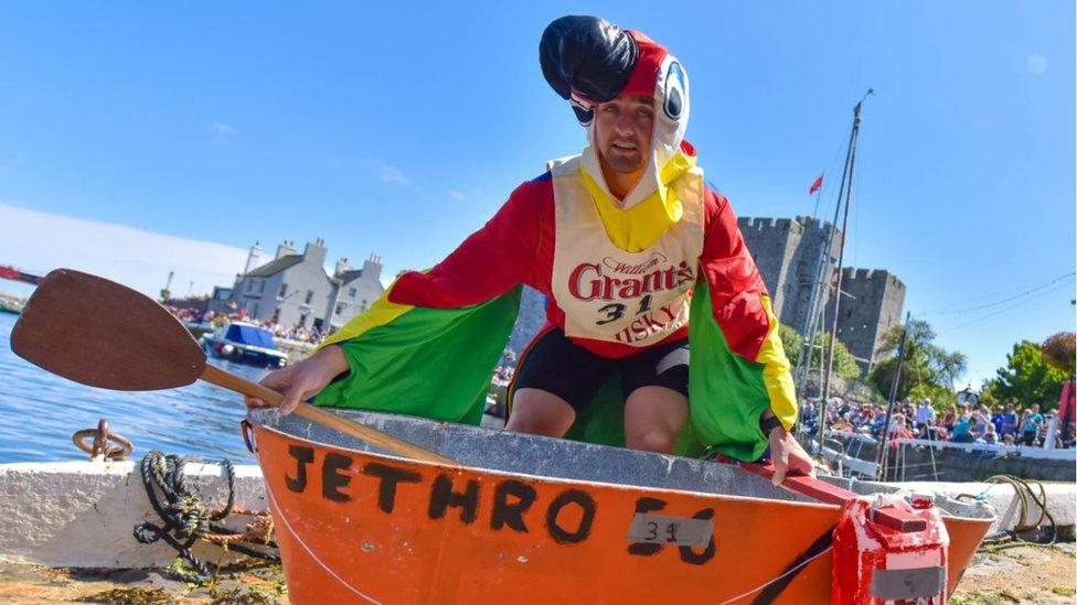 A competitor dress as a parrot with an orange tin bath