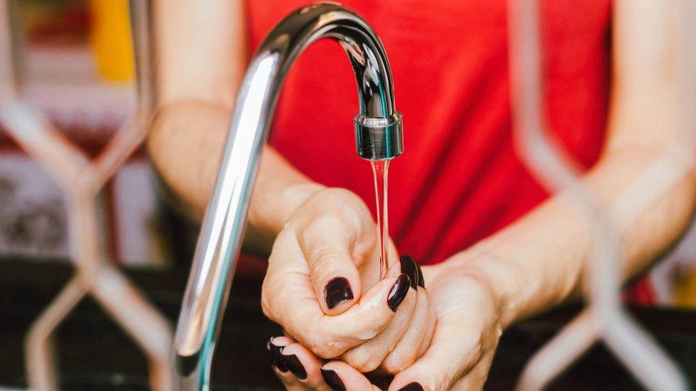 woman washes her hands