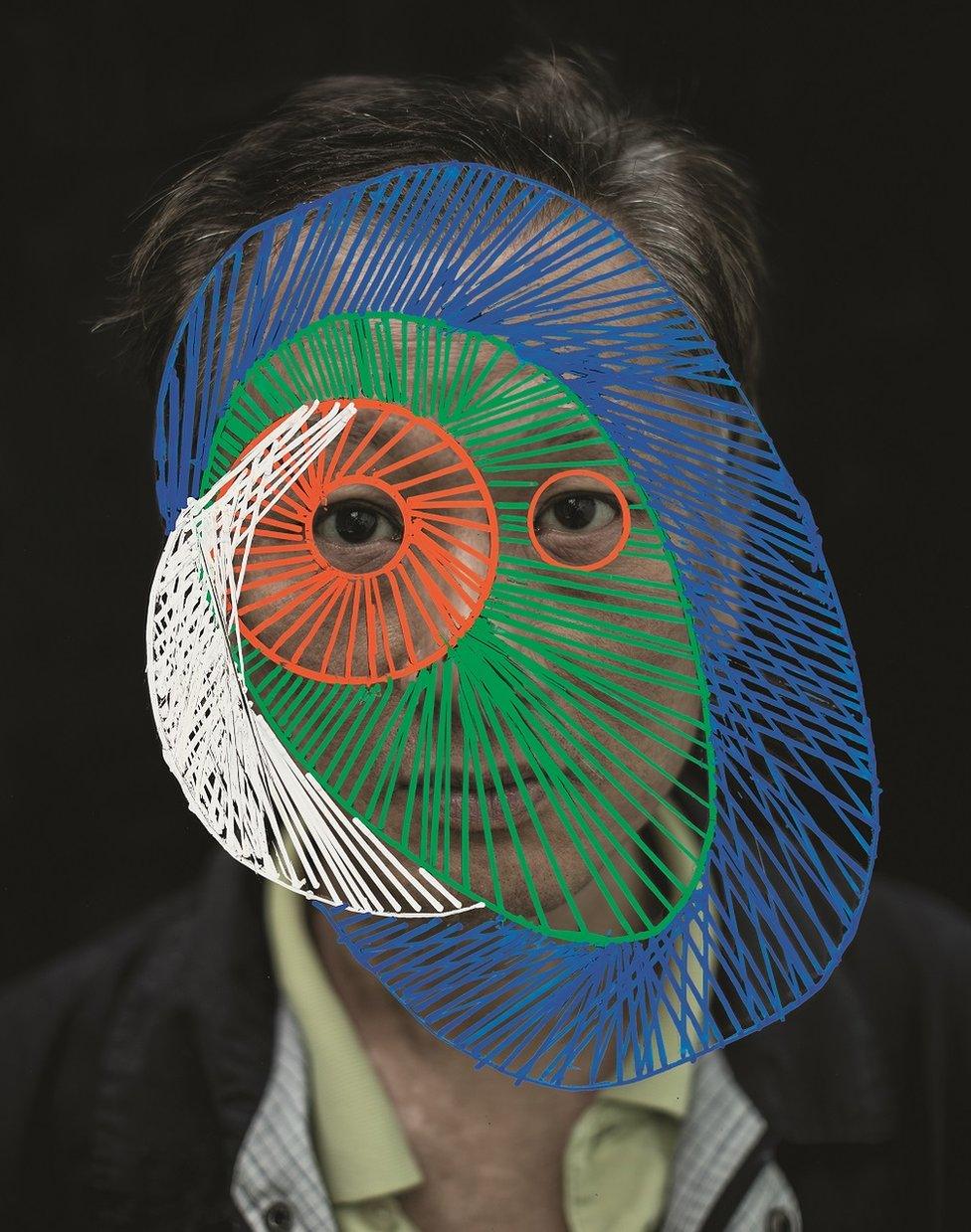 A man with circles drawn over his face.