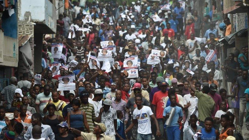 Supporters of presidential candidate Maryse Narcisse of Lavalas display party posters during a march in support of their candidate in Port-au-Prince November 21, 2016