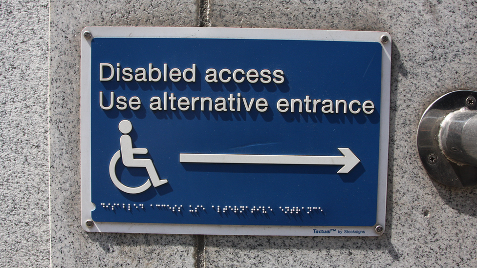 Disabled access notice in Braille to use alternative entrance