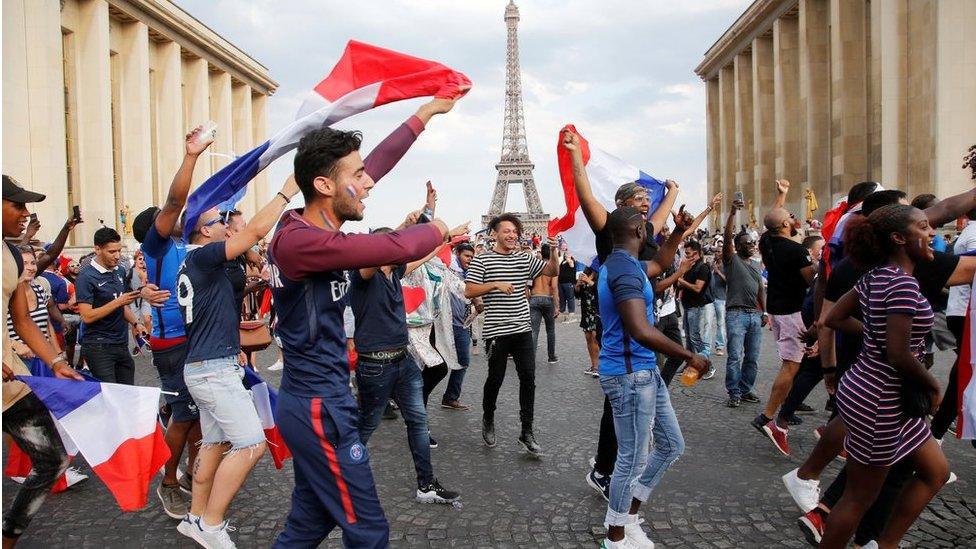 French fans in Paris celebrate in front of the Eiffel Tower, 15 July 2018