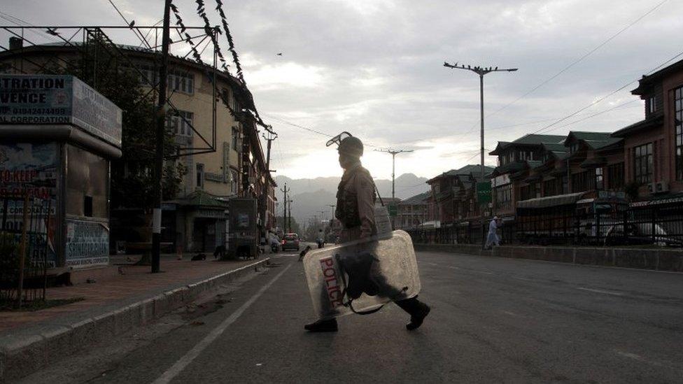 An Indian paramilitary soldier patrols during curfew in Srinagar, Indian-controlled Kashmir, Monday, Aug. 22, 2016.