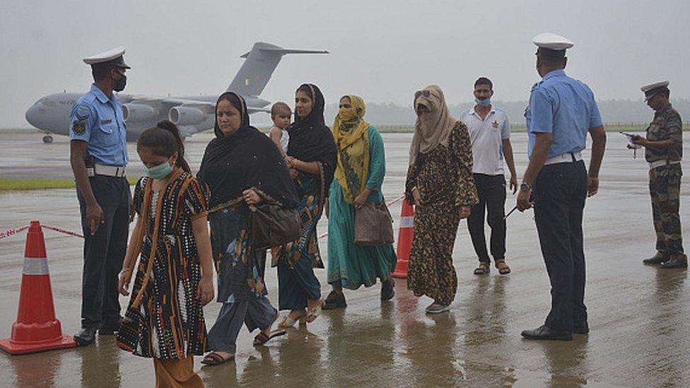 Passengers disembark from Indian Air Force's C-17 Globemaster at Hindon Air Force Station after being evacuated from Kabul