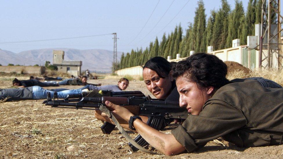 Young Syrian-Kurdish women take part in a training session organized by the Kurdish Women's Defence Units in 2013, in the northern Syrian border village of al Qamishli,