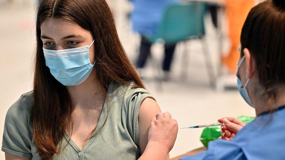 Teenager receives a covid vaccination at a vaccination centre on August 9, 2021, in Barrhead, Scotland