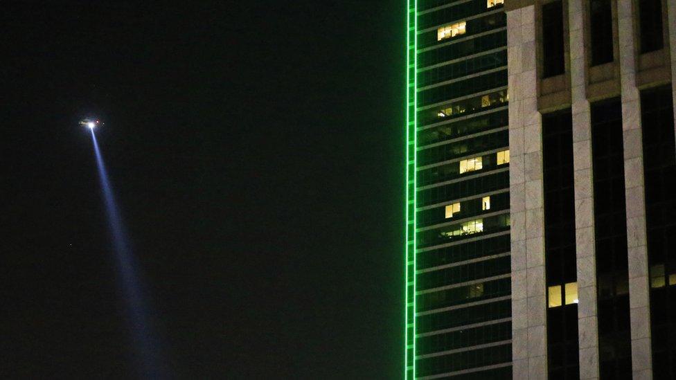 A helicopter flies over the scene where twelve police officers were shot in Dallas - July 2016