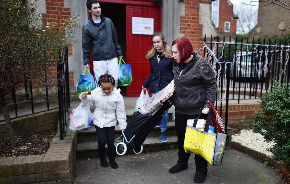 young family leave food bank