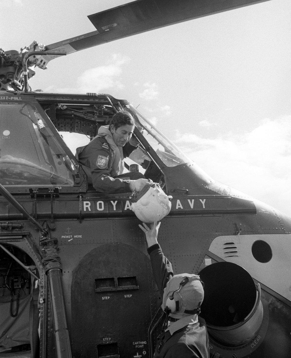 Naval Lieutenant the Prince of Wales being handed his flying helmet