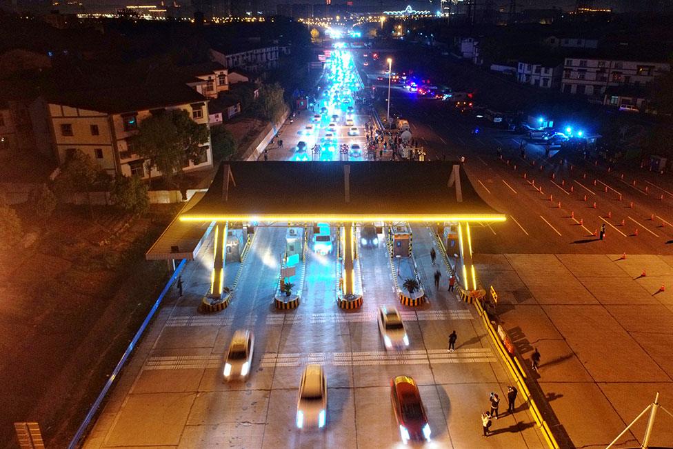 Vehicles travel through a toll station