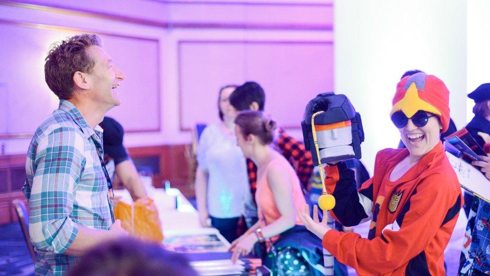 James Roberts amused by a fan's replica head of Trailbreaker at TFNation 2017