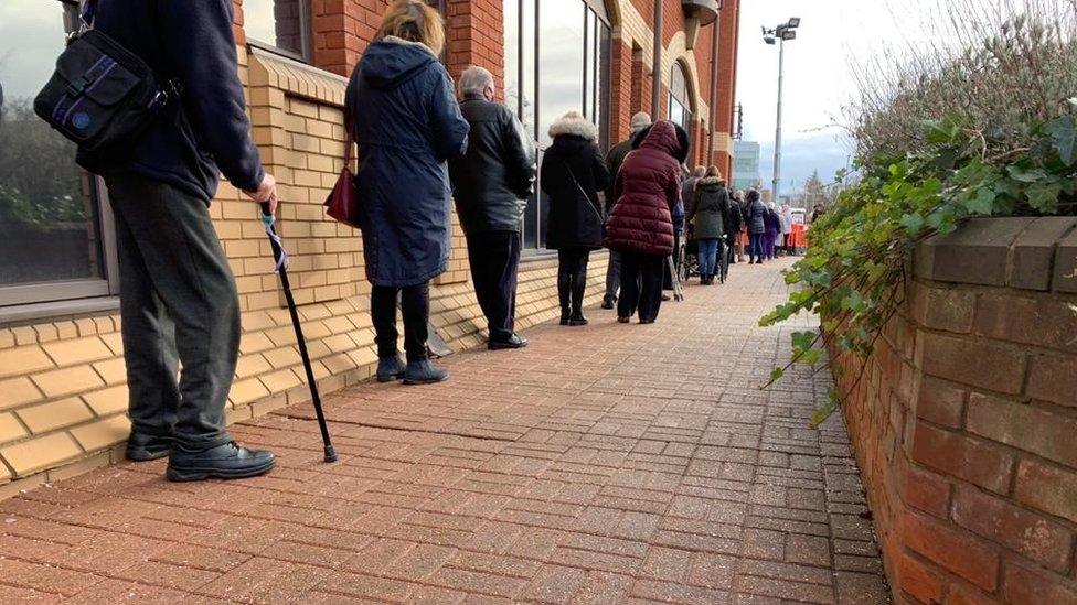 People queueing outside Robertson House in Stevenage for their vaccine