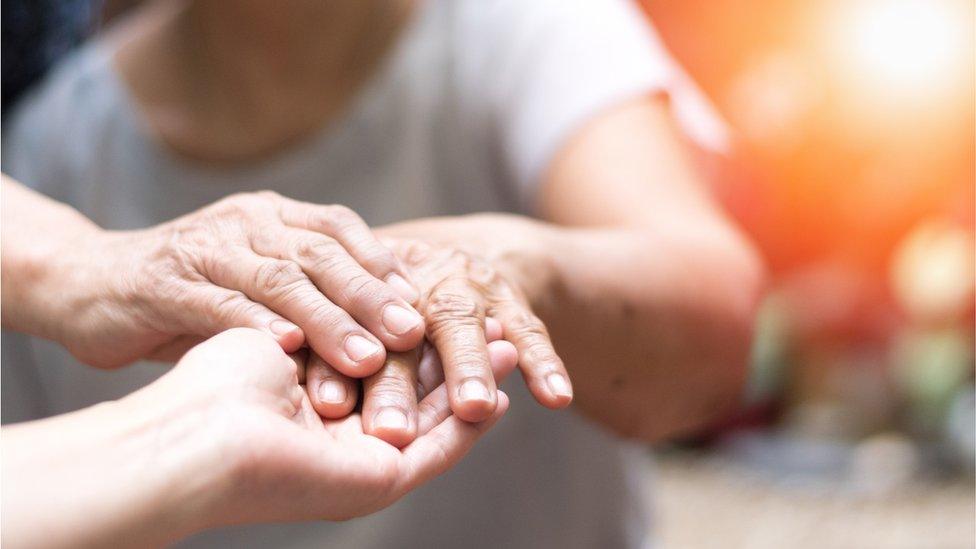 A person holding another person's hand