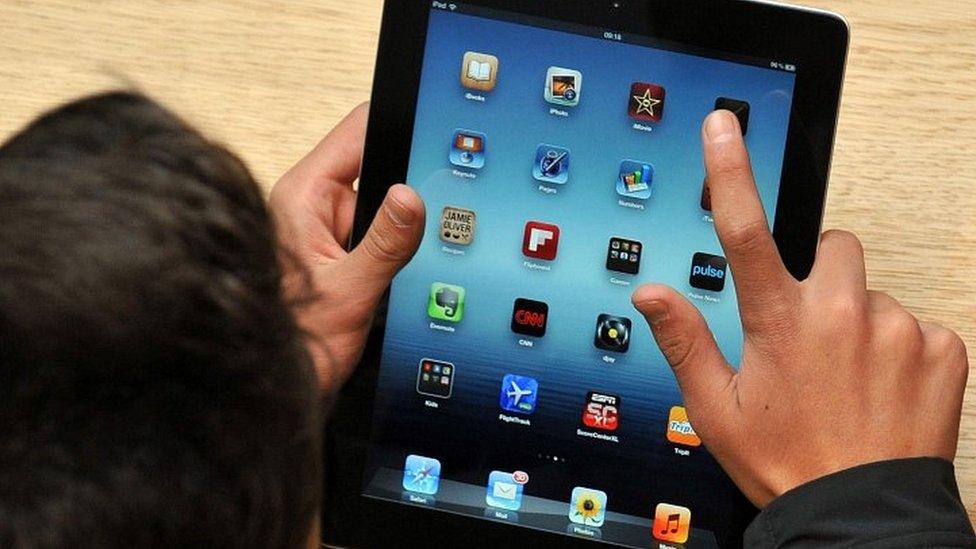 Man holding iPad tablet