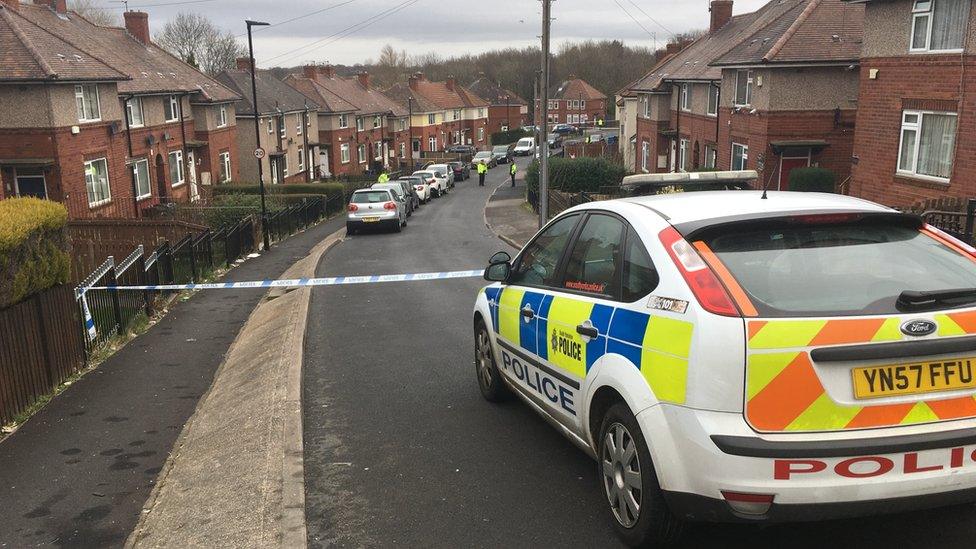 Police car parked up in front o a cordon