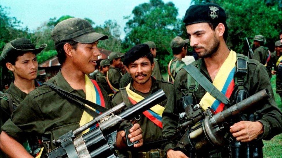 Farc guerrilla fighters pose with their weapons after a patrol in the jungle near the town of Miraflores, Colombia, August 7, 1998